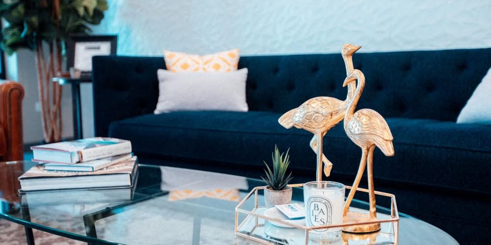 a living room with a blue couch and a glass coffee table at Barrington 101, Barrington Illinois