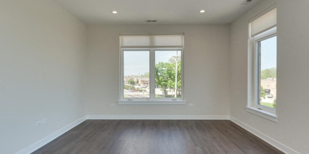 a empty living room with a window and wooden floors  at Highwood 246, Illinois, 60040