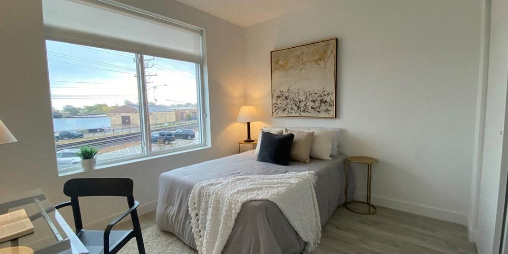 a living room with a table and a large window at Highwood 546, Highwood, IL