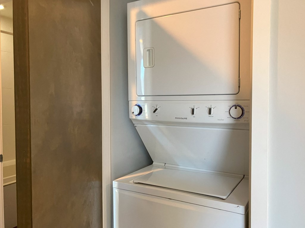 an empty laundry room with a washer and dryer