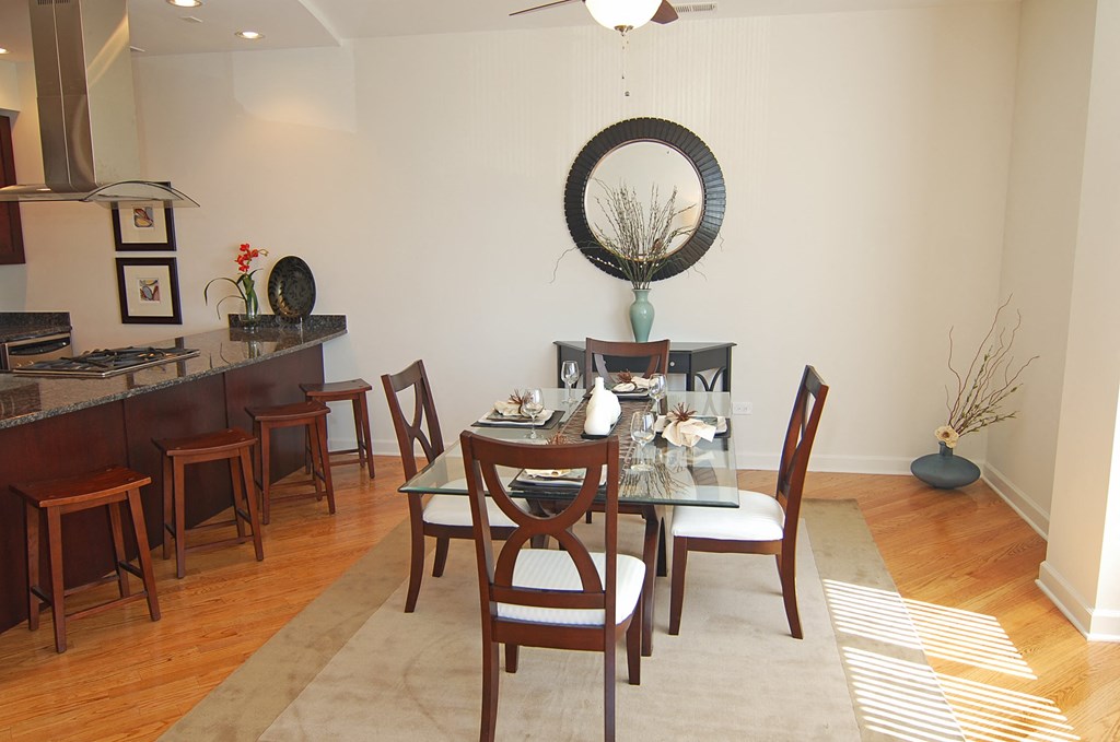 a dining room with a glass table and chairs