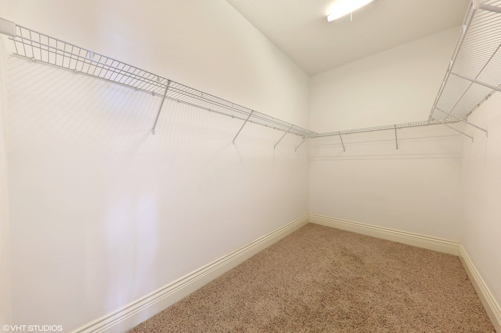 a room with a carpeted floor and a closet with white and blue walls