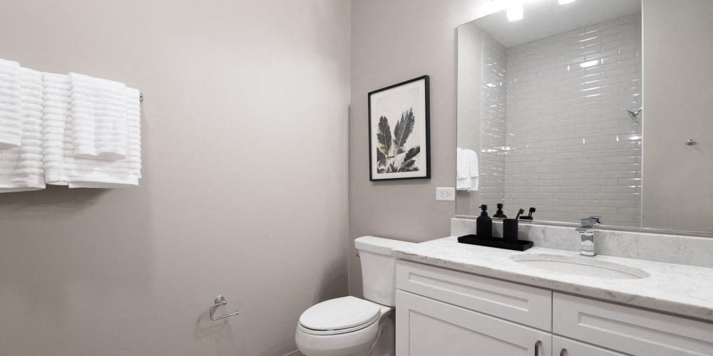 a bathroom with a sink toilet and a mirror  at Clark 2050, Chicago