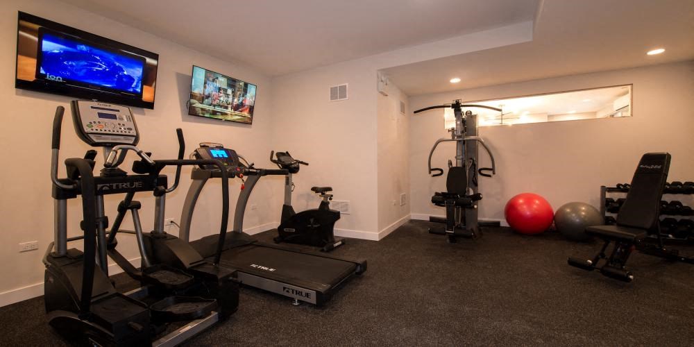 a home gym with exercise equipment and a tv  at Kedzie 4447, Chicago, IL, 60625