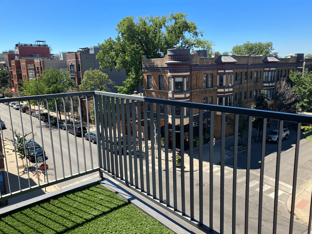 a balcony with a view of a city street and buildings