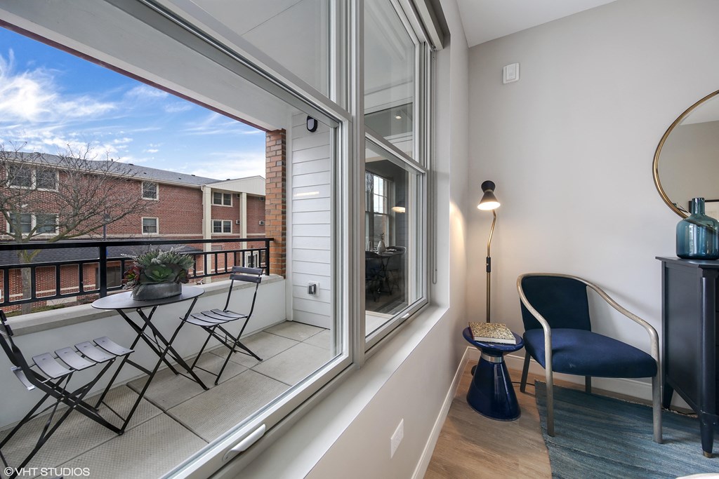 a balcony with a chair and a table and a large window at Clarendon Hills 229, Illinois
