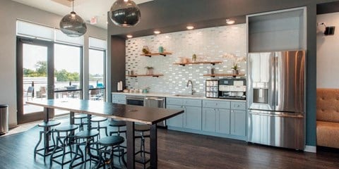 a kitchen with a bar and a stainless steel refrigerator at Barrington 101, Barrington, IL