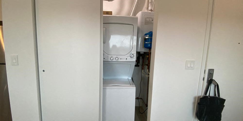 a white washer and dryer in a white closet at Highwood 546, Highwood Illinois