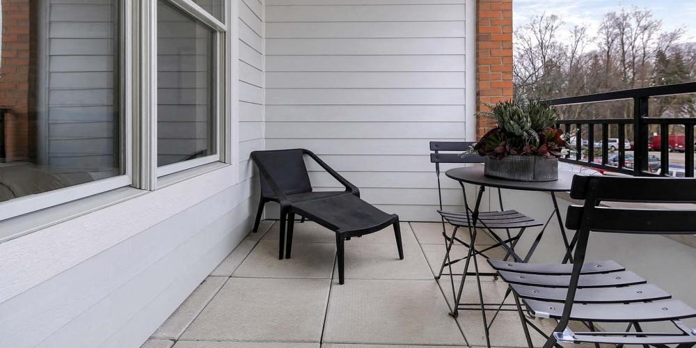 a balcony with a table and chairs and a window at Clarendon Hills 229, Clarendon