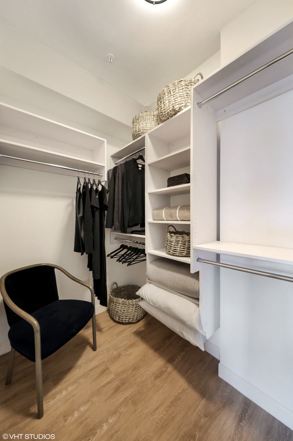 a walk in closet with a chair in front of a white closet door at Clarendon Hills 229, Clarendon, IL