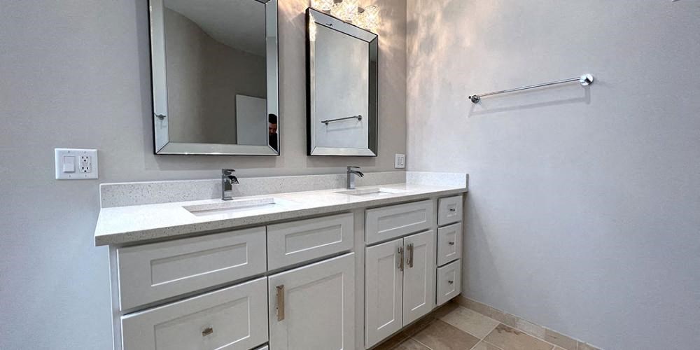 a bathroom with two sinks and two mirrors  at Lavergne 4810, Chicago, IL, 60630