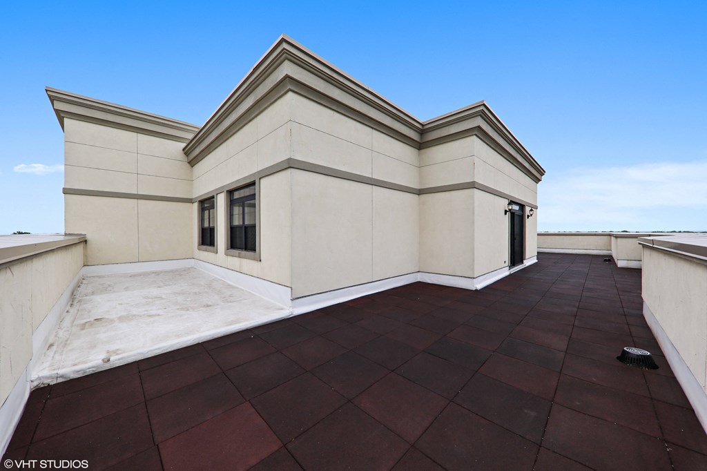 a large roof terrace with a blue sky in the background