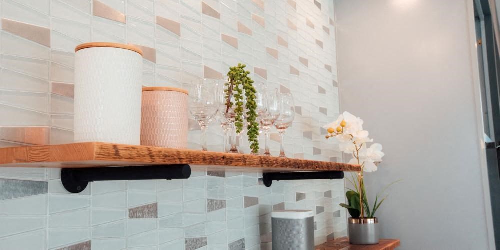a shelf with wine glasses and flowers on it at Barrington 101, Chicago