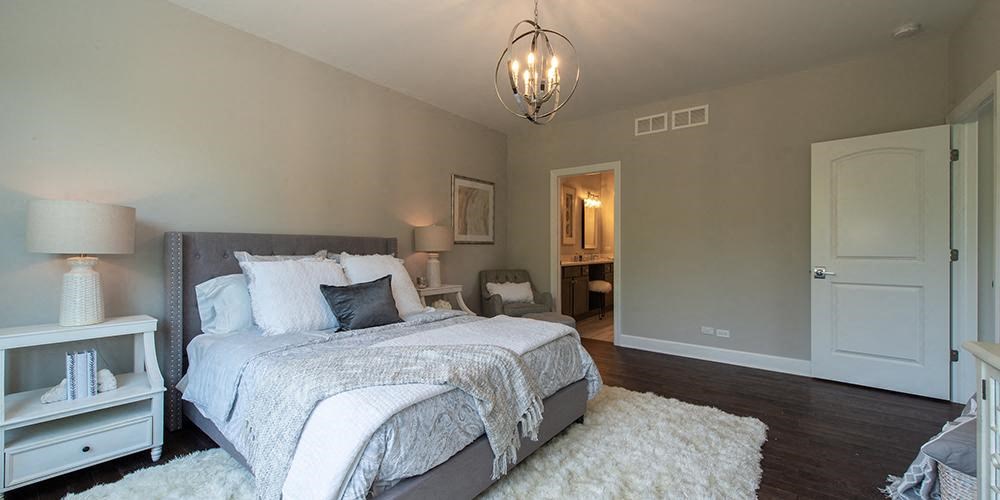 a bedroom with a bed and a white rug at Countryside Townhomes, Countryside