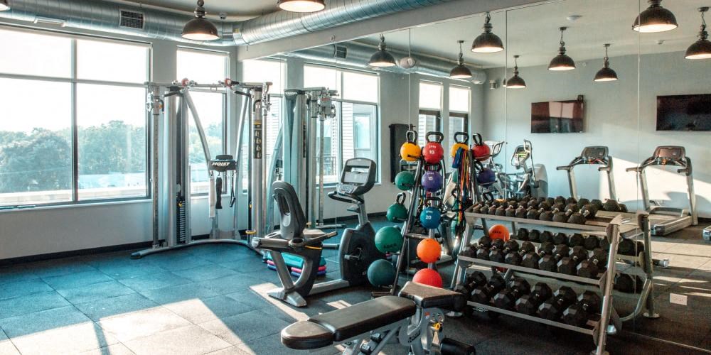 a gym with a lot of weights and a large window  at Barrington 101, Barrington Illinois