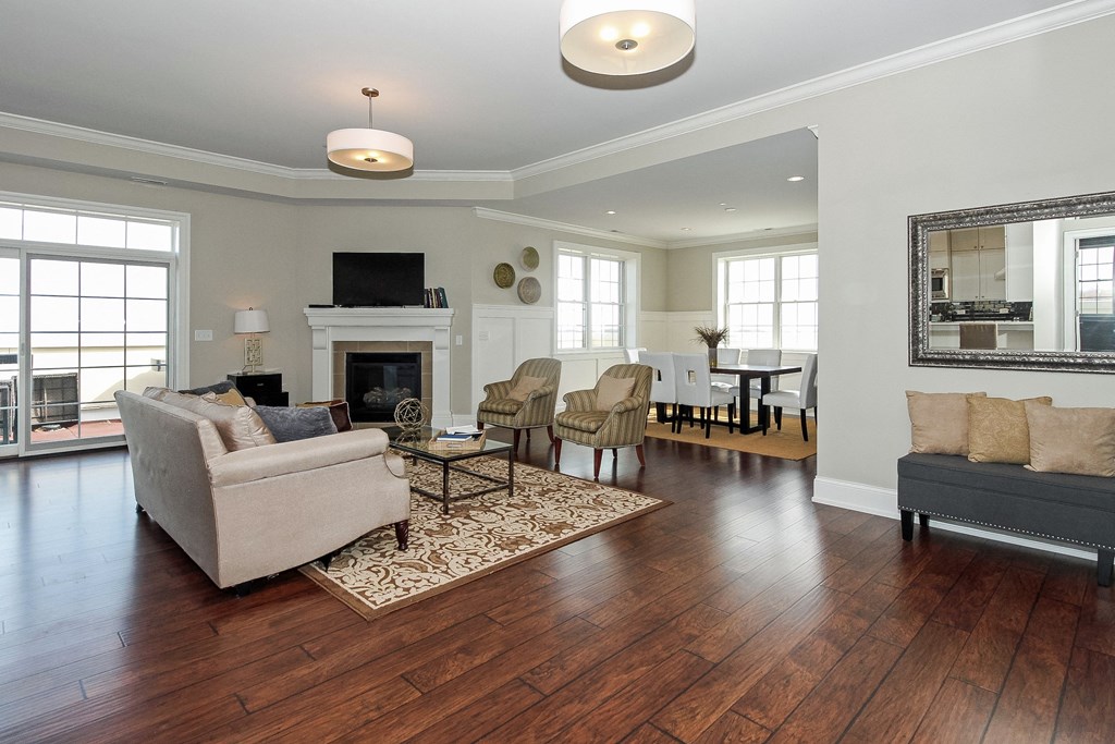 a living room with couches and chairs and a fireplace