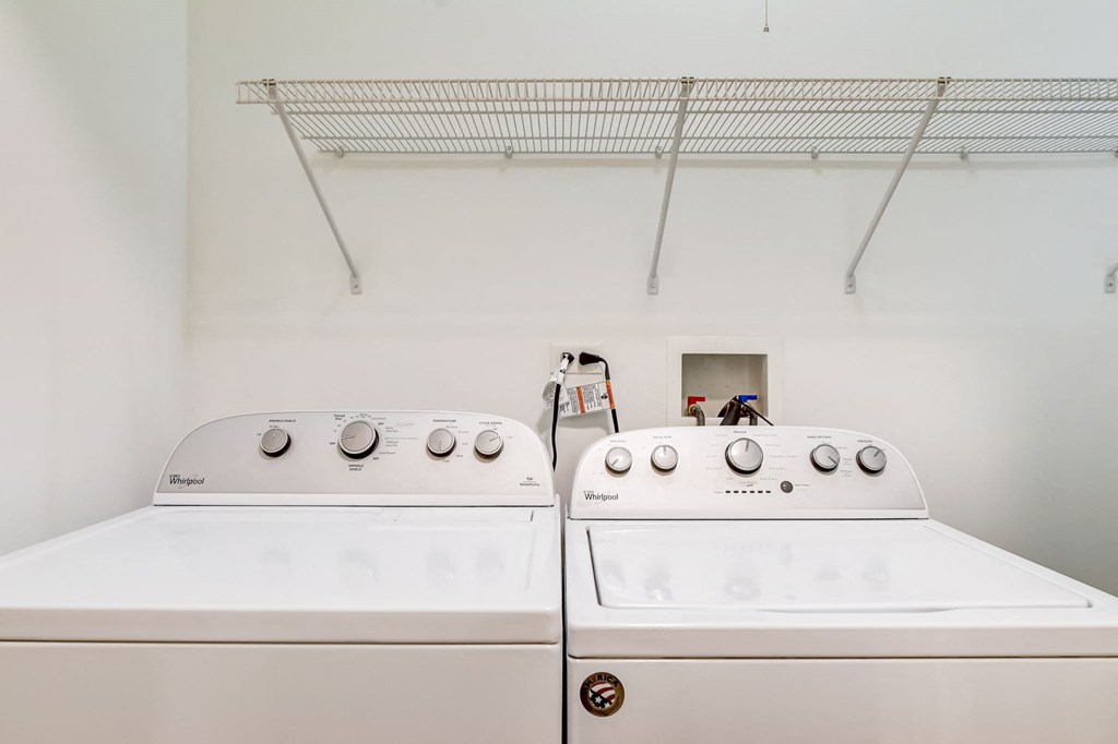 two washers and dryers in a laundry room with a rack on the wall at Clarendon Hills 229, Clarendon Illinois