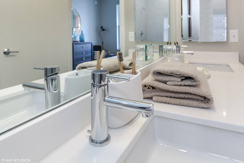 a bathroom with a sink and a mirror and towels at Clarendon Hills 229, Clarendon Illinois