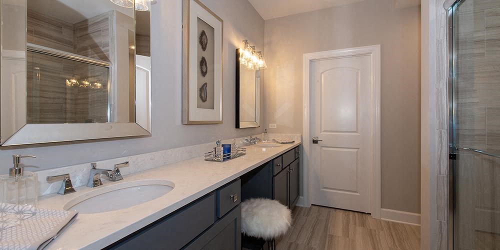 a bathroom with two sinks and a mirror at Countryside Townhomes, Illinois, 60525