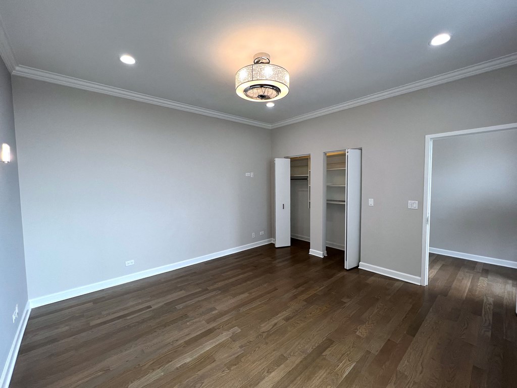 a living room with a hardwood floor and grey walls