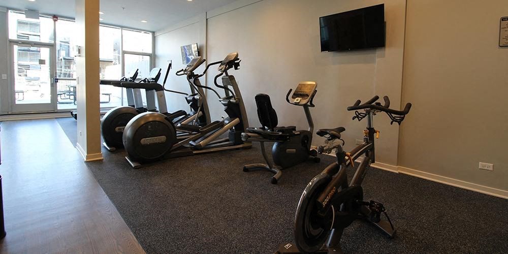a gym with several exercise bikes and a tv  at Fullerton 1540, Chicago