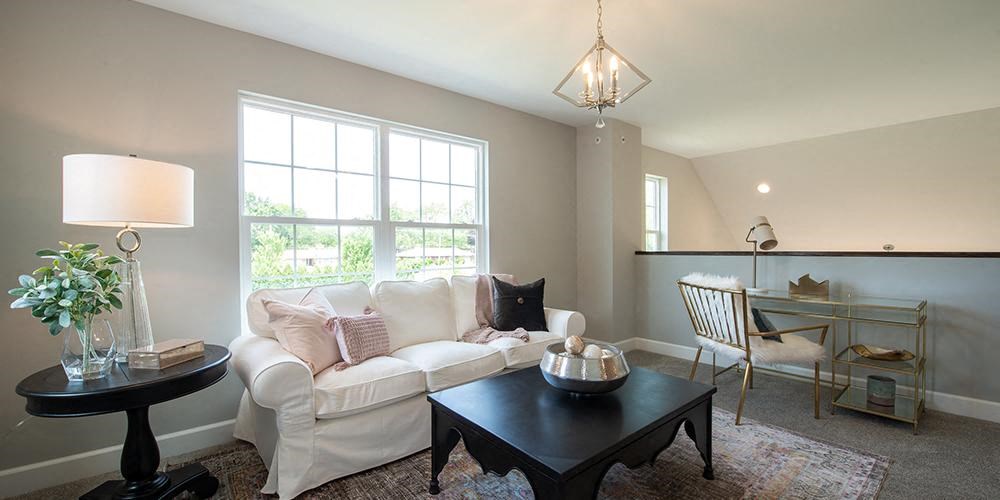 a living room with a white couch and a table at Countryside Townhomes, Countryside Illinois