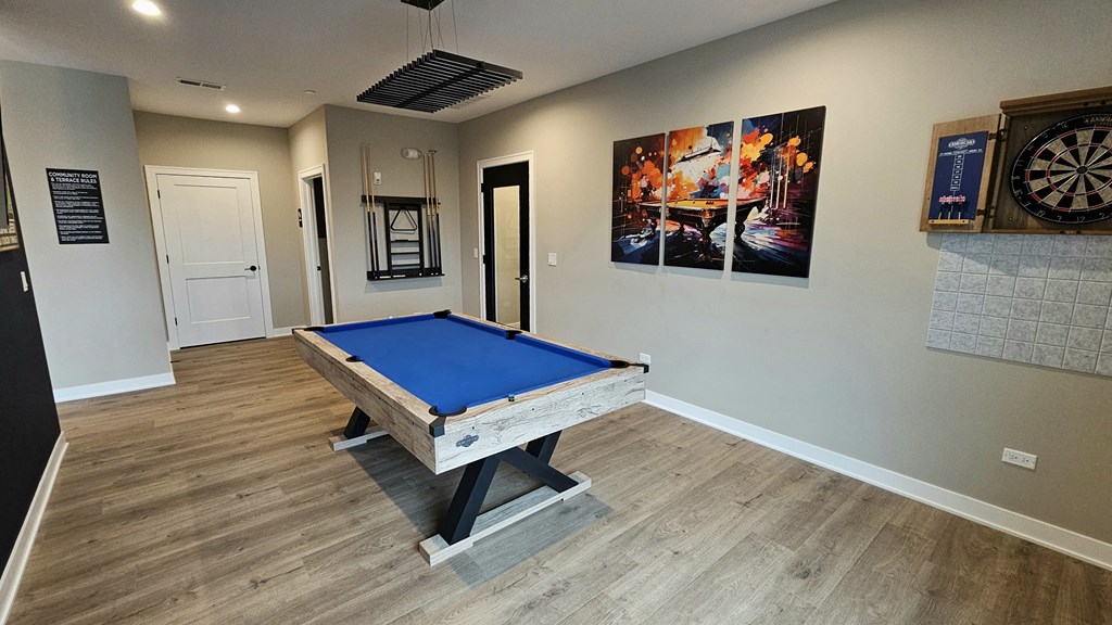 a games room with a pool table in a house