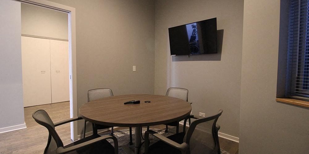 a dining room table with a television on the wall  at Fullerton 1540, Chicago, IL, 60614