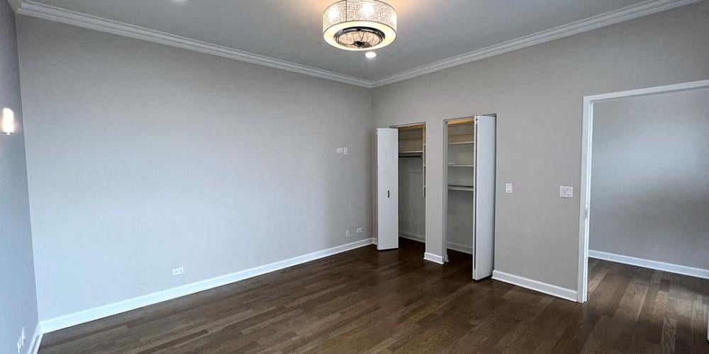 a empty living room with a wood floor and a closet  at Lavergne 4810, Illinois