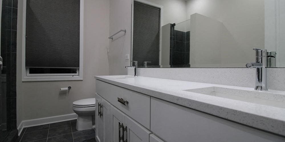 a white bathroom with a sink and a toilet  at Elston 3434, Chicago, IL