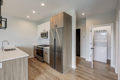 a kitchen with stainless steel appliances and a refrigerator