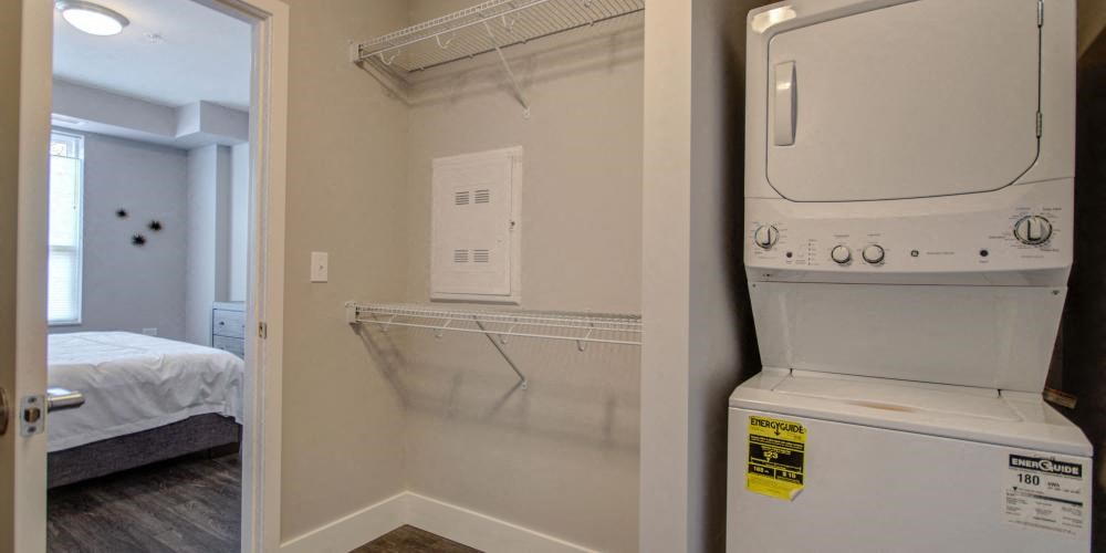 a white washer and dryer in a room next to a bedroom at Barrington 101, Illinois, 60010