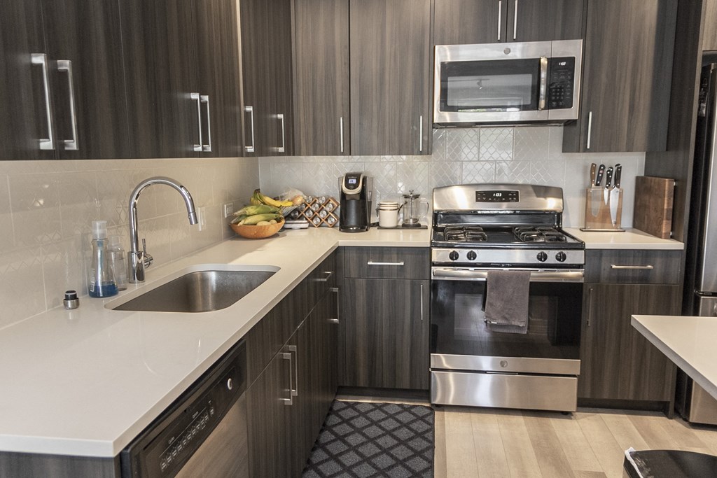 a kitchen with stainless steel appliances and wooden cabinets at Talman 1554, Chicago, 60622