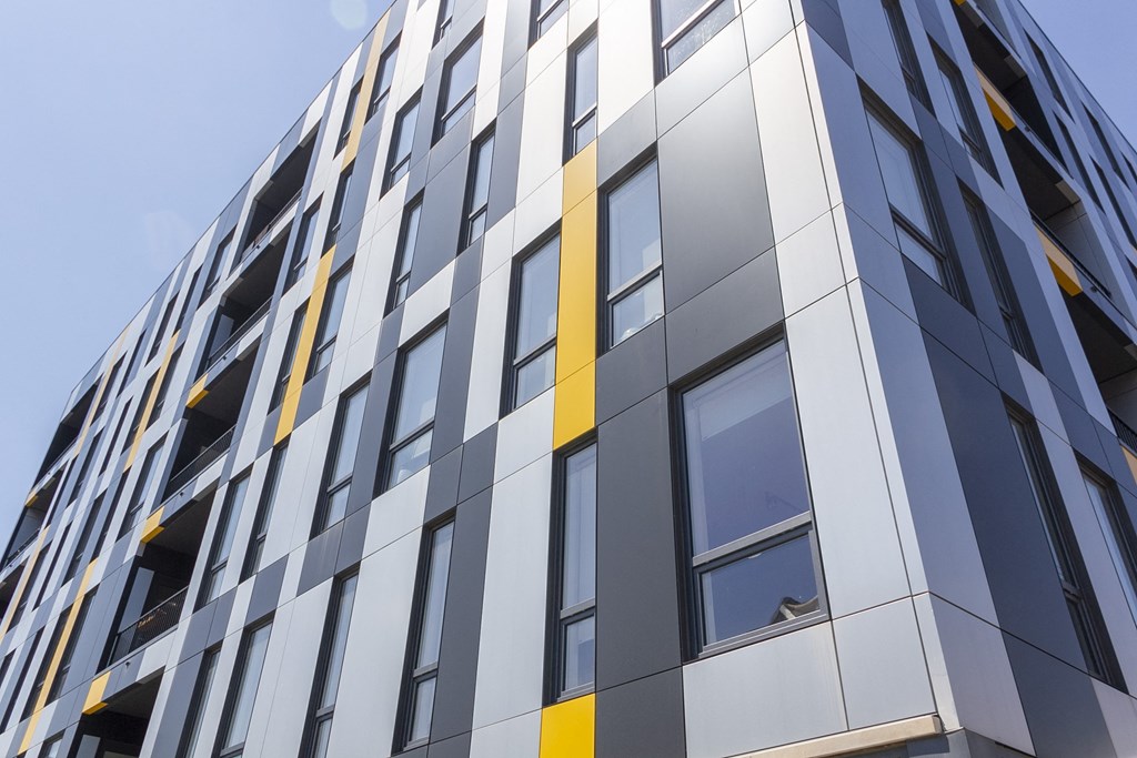 the facade of a high rise building with yellow and silver panels at Talman 1554, Chicago, IL