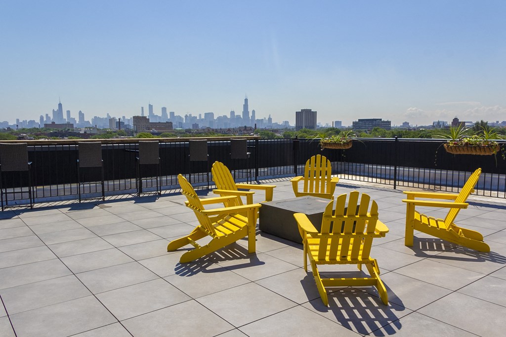 a rooftop patio with yellow chairs and a view of the city at Talman 1554, Chicago, IL