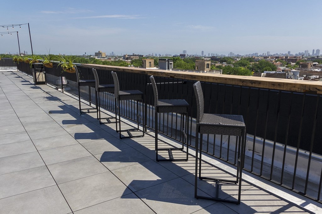 a row of chairs on a roof overlooking a city at Talman 1554, Chicago