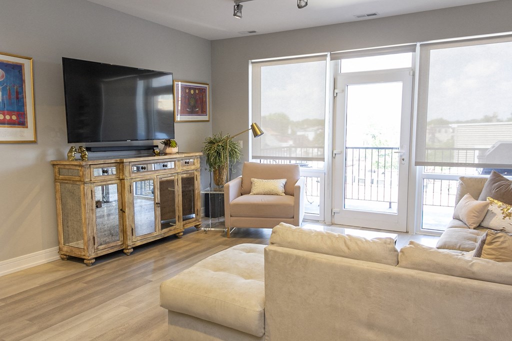 a living room with a couch and a tv and a balcony at Talman 1554, Chicago, 60622