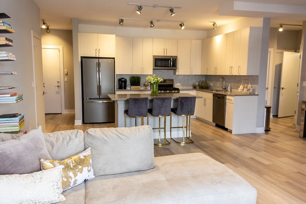 a kitchen with stainless steel appliances and a living room with a couch at Talman 1554, Chicago, IL 60622