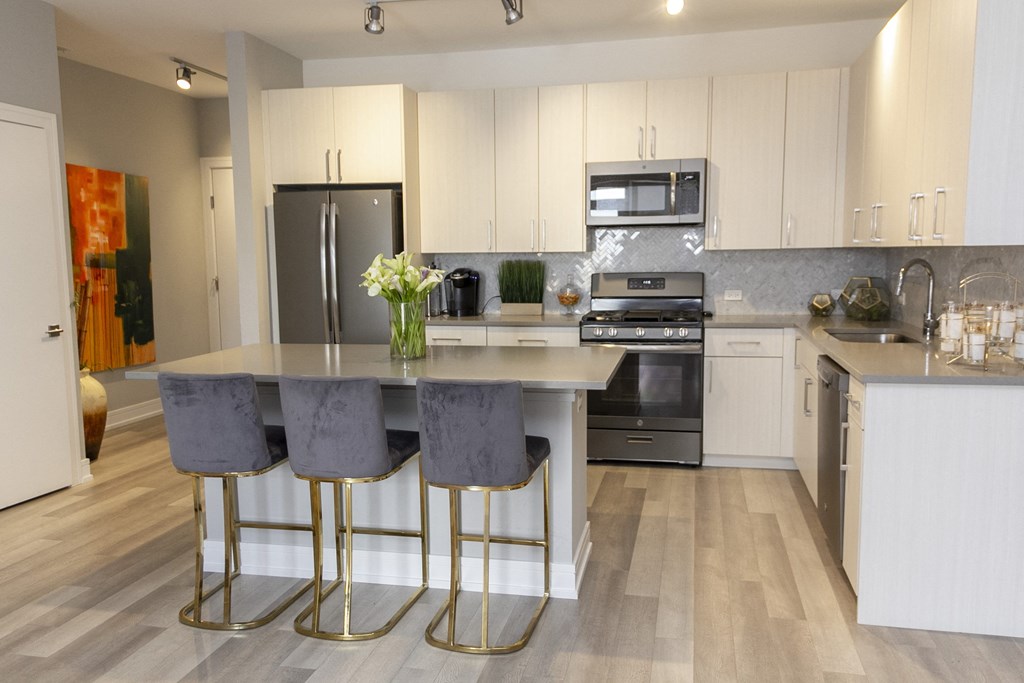 a modern kitchen with white cabinets and stainless steel appliances at Talman 1554, Chicago, 60622
