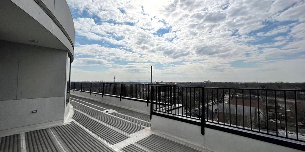 a balcony with a view of a building and a cloudy sky  at Lavergne 4810, Chicago, IL, 60630
