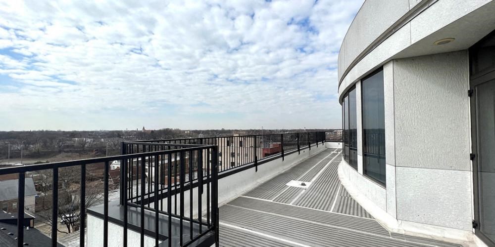 a balcony with a view of a city and a cloudy sky  at Lavergne 4810, Illinois, 60630