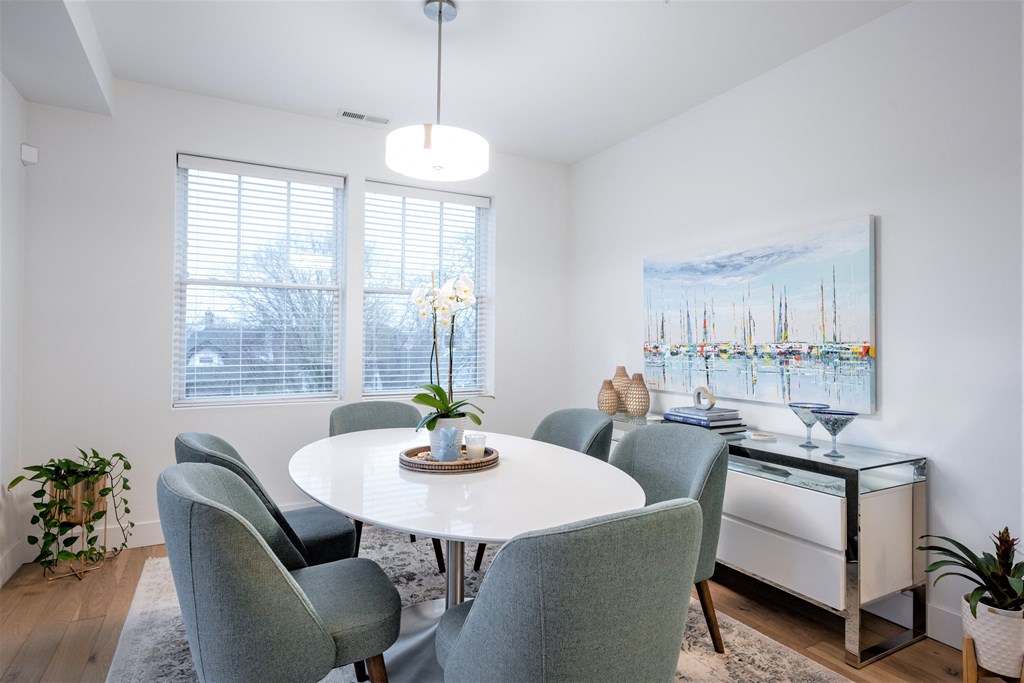 a dining room with a white table and chairs