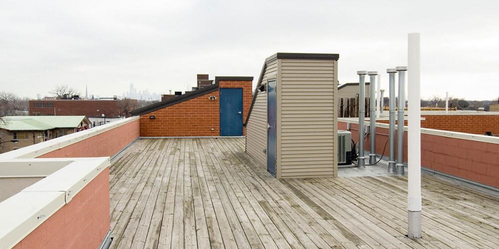 the roof of a building with a wooden deck  at Elston 3434, Chicago, IL