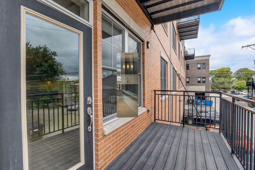 the view from the balcony of a brick building with a wooden deck at Clarendon Hills 229, Illinois