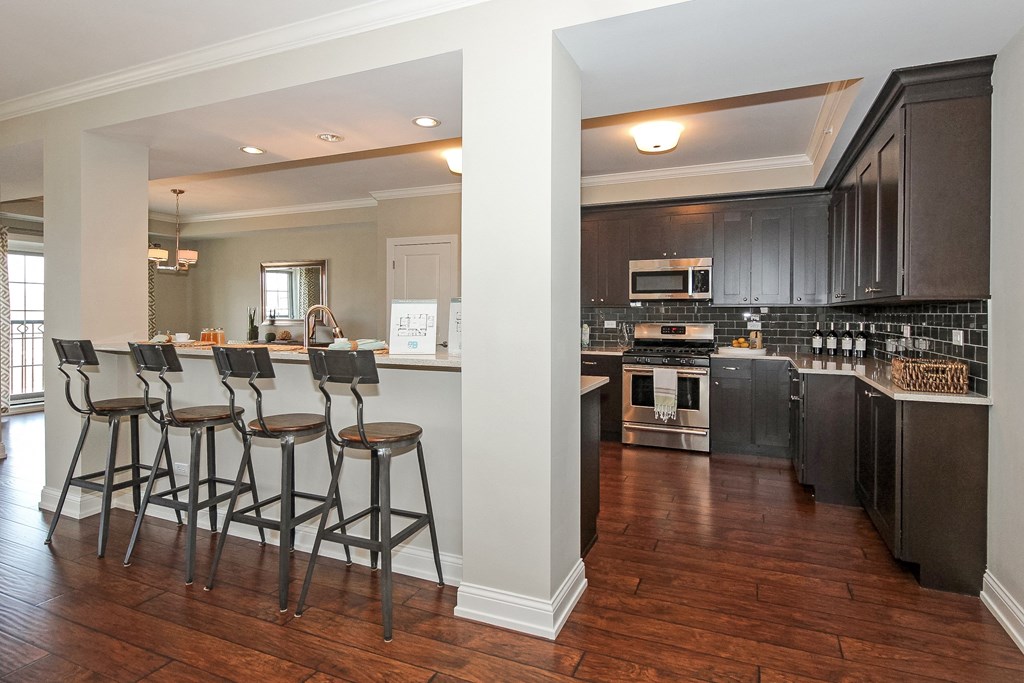 a view of a kitchen with a bar and stools  at Countryside 10765, Countryside, Illinois