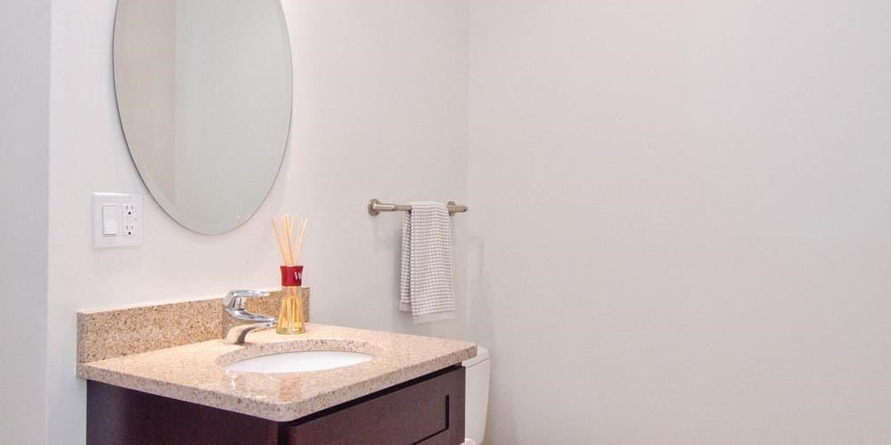 a bathroom with a sink and a mirror  at Lavergne 4810, Chicago