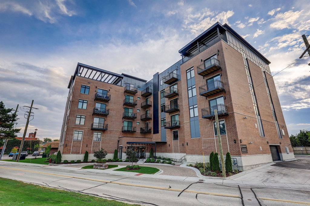 a red brick building with balconies on the side of a street at Highwood 440, Highwood