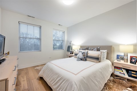 a bedroom with a large bed and a tv