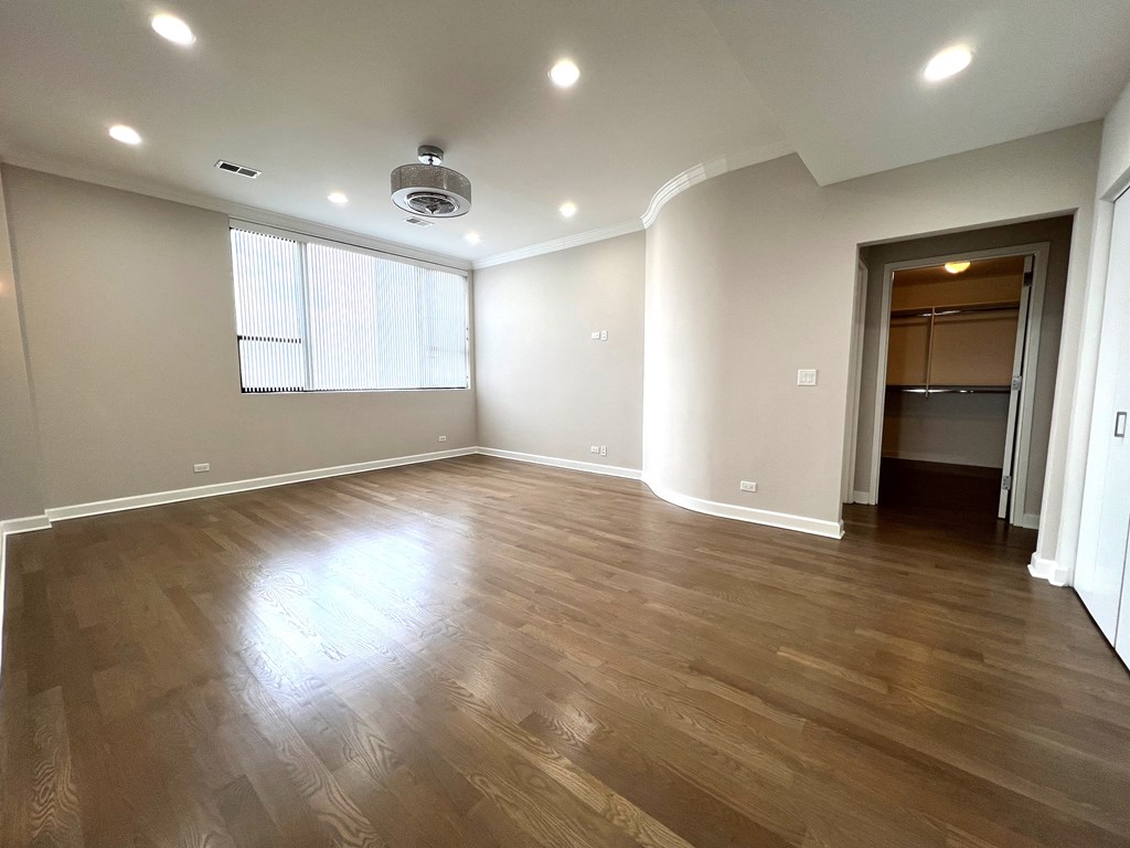 an empty living room with hardwood floors and a window