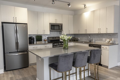 a kitchen with stainless steel appliances and white cabinets